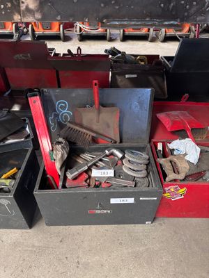 many different tools in a box on the floor