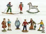 many figurines of people on display on a shelf