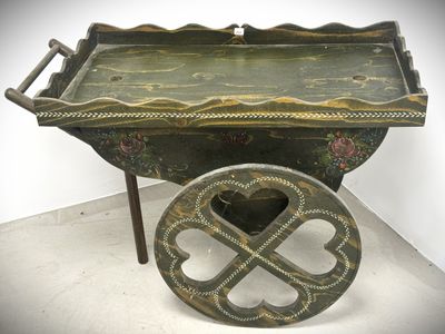 a small wooden cart with a wheel on the floor