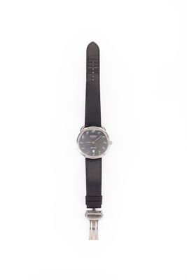 black leather strap watch with black dial on white background