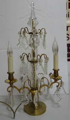 a small crystal chandelier with three candles on it