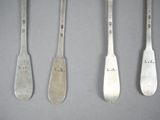 four silver spoons with the names of different types of spoons on them