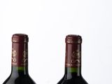 two bottles of wine sitting next to each other on a table