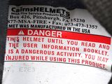 a label on the back of a motorcycle that says danger