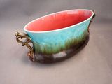 a bowl that is sitting on a table with a handle