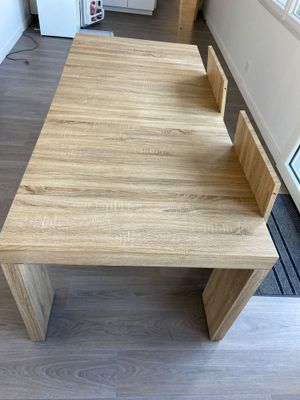 a wooden table with a bench in the middle of it
