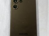 a close up of the back of a brown samsung phone