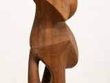 sculpture made of wood on a white pedestal with a white background