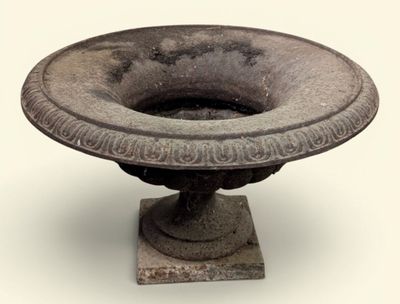 a stone bowl on a pedestal on a white background