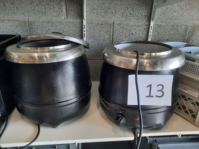 two pots that are sitting on a shelf next to each other