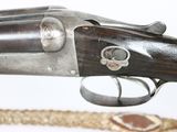 an old gun is sitting on a table with a rope around it
