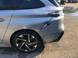 a silver car that is parked in a parking lot