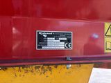 a sign on the back of a red dump truck