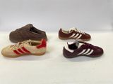 three pairs of adidas shoes are lined up on a white surface