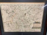 an old map of england in a black frame with a red border