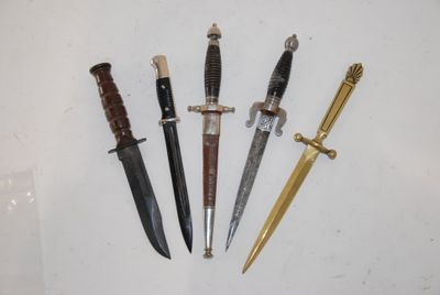 four different types of knives are displayed on a white surface
