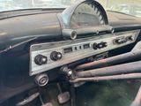 a dashboard of an old car with a clock on it