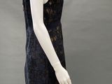 an image of a mannequin wearing a black and gold dress