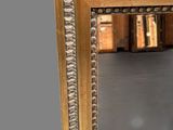 a mirror that is sitting on a table in a room