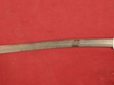 a picture of a sword that is on a red surface