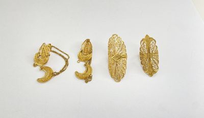 three pairs of gold earrings on a white surface