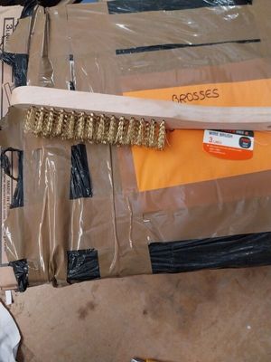 a broom that is sitting on top of a cardboard box
