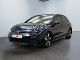 a blue volkswagen golf gtr parked in a showroom