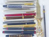 many pens and a pair of scissors on the table