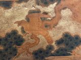 a painting on the wall of a building with a dragon on it