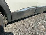 a close up of a white truck with a flat tire
