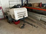 a machine that is sitting in a garage next to a car