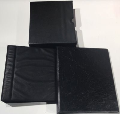 three black leather folders sitting on top of a white table