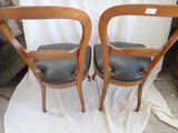 two chairs that are sitting next to each other