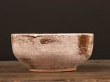a close up of a bowl on a wooden table