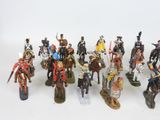 a lot of figurines that are on a white surface