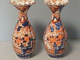 two vases that are sitting on a table