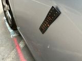 a sticker on the side of a silver car