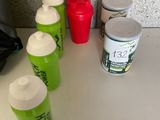 many cups of water sitting on the counter next to each other
