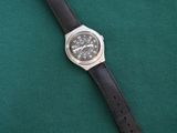 a watch that is laying on a green cloth