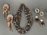 several pieces of jewelry are displayed on a gray surface