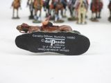figurines of people riding horses and a man on a horse