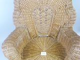 woven wicker chair on white background with label on seat
