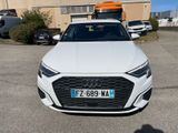 the front end of a white audi car parked in a parking lot
