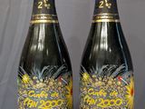 two bottles of champagne sitting on top of a wooden table