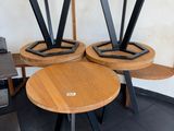 three wooden tables with metal legs on them in a room