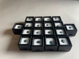 a lot of small black boxes with green gems in them