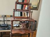 a wooden shelf with a mirror on it in a living room
