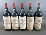 six bottles of wine are lined up in a row
