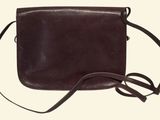 brown leather cross body bag with shoulder strap on a white background