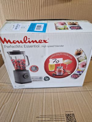 the box of a blender is sitting on a cardboard box